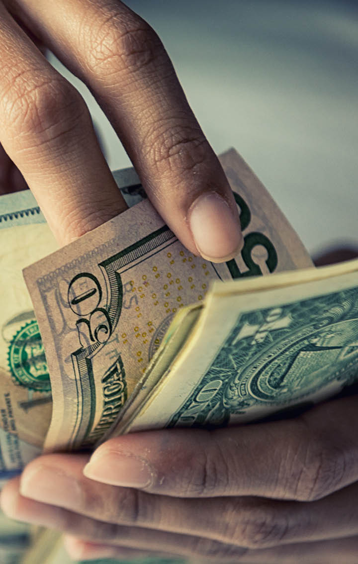 Close-up Hands counting money American dollars , Counting money American dollars with hand , Vintage tone effect , Income and Business concept.