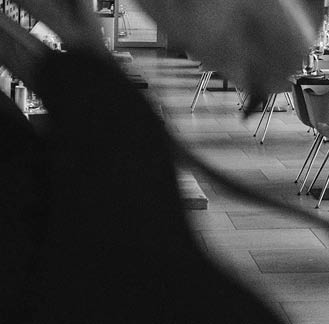 A woman is sitting at a table in a restaurant. AI generated content