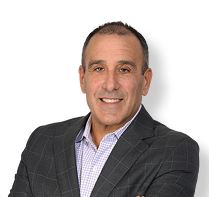 A man wearing a suit and tie is smiling for the camera. AI generated content