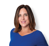 A woman wearing a blue dress and a white shirt is smiling for the camera. AI generated content