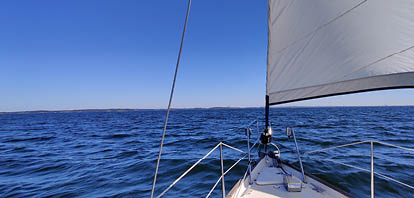 Luxury cruise on a sailing rigged yacht under a genoa and mainsail sailing in a light wind during the regatta. Yachting as a luxury sport and great vacation