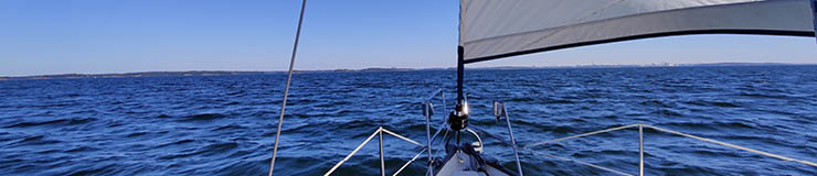 Luxury cruise on a sailing rigged yacht under a genoa and mainsail sailing in a light wind during the regatta. Yachting as a luxury sport and great vacation