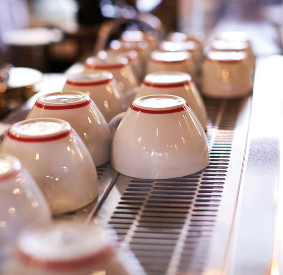 Close Up Of Cups Arranged On Machine In Coffee Shop