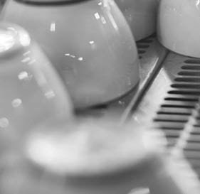 Close Up Of Cups Arranged On Machine In Coffee Shop