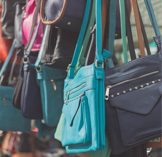 Colorful handbags hanging in a stall at a market