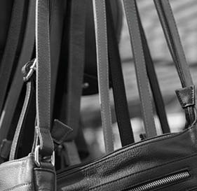 Colorful handbags hanging in a stall at a market